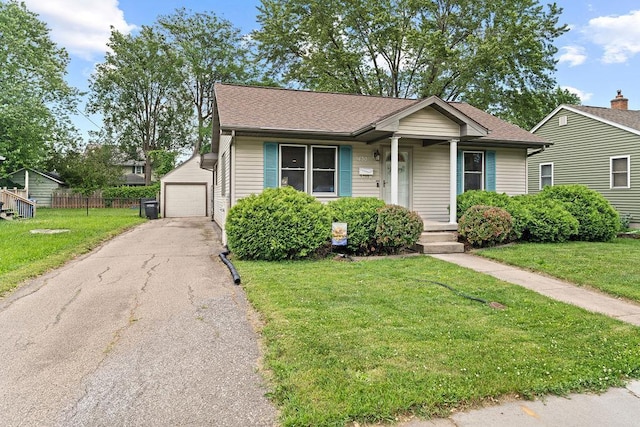 1630 Central St, Oshkosh, WI 54901 - view of front of property with a detached garage, an outbuilding, asphalt driveway, and roof with shingles