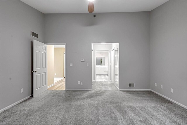 2855 River Birch Dr Unit D, Brookfield, WI 53045 - unfurnished bedroom with carpet floors, a towering ceiling, connected bathroom, and ceiling fan
