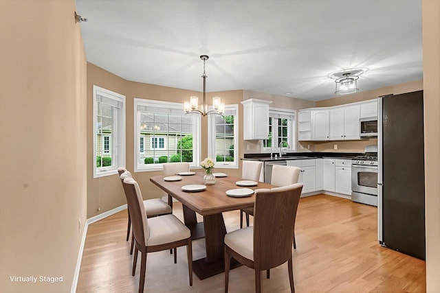 2855 River Birch Dr Unit D, Brookfield, WI 53045 - dining area featuring healthy amount of natural light, a chandelier, and light wood finished floors