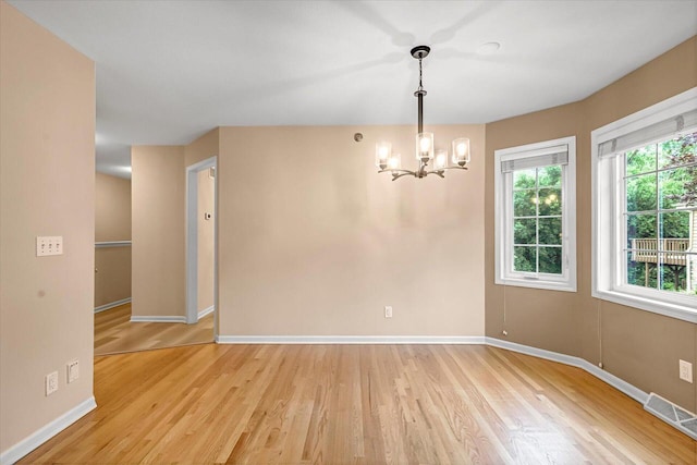 2855 River Birch Dr Unit D, Brookfield, WI 53045 - empty room featuring a chandelier and light wood finished floors
