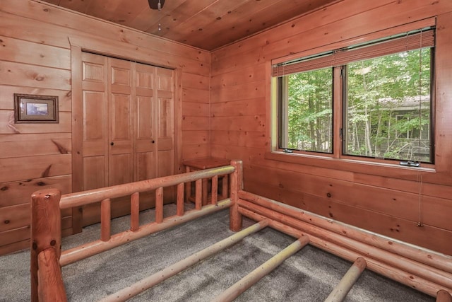 1780 Amik Lake Ln, Lac Du Flambeau, WI 54538 - unfurnished bedroom with carpet flooring, wood ceiling, wood walls, and a closet