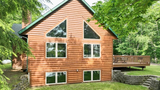 1780 Amik Lake Ln, Lac Du Flambeau, WI 54538 - rear view of house with a wooden deck, a yard, faux log siding, and a chimney