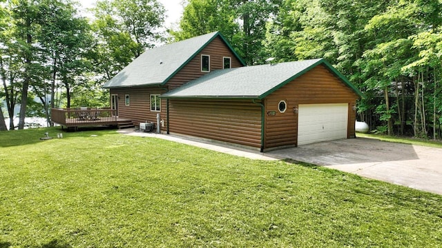 1780 Amik Lake Ln, Lac Du Flambeau, WI 54538 - view of front of property with log veneer siding, a wooden deck, a front yard, a shingled roof, and a detached garage