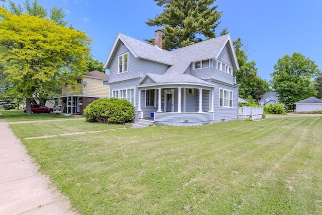 305 N Center Ave, Merrill, WI 54452 - view of front facade featuring a chimney, covered porch, a front lawn, and a shingled roof