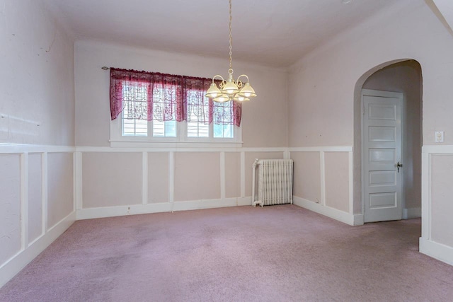 305 N Center Ave, Merrill, WI 54452 - carpeted empty room with radiator, arched walkways, and a chandelier