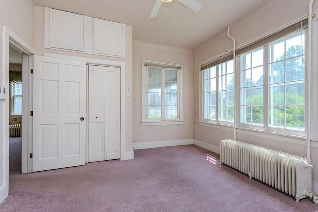 305 N Center Ave, Merrill, WI 54452 - carpeted bedroom with radiator heating unit, a closet, and ceiling fan