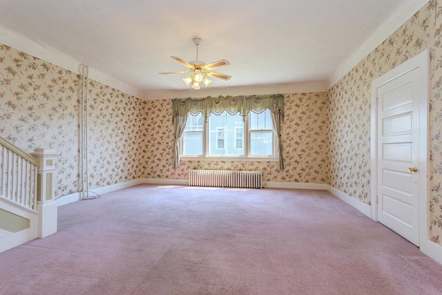 305 N Center Ave, Merrill, WI 54452 - empty room featuring radiator, light carpet, a ceiling fan, stairway, and wallpapered walls