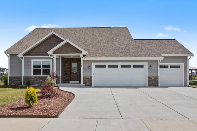1451 Whalen Dr, Oconomowoc, WI 53066 - craftsman-style house featuring an attached garage, stone siding, and concrete driveway