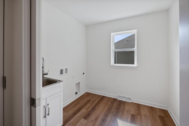 1451 Whalen Dr, Oconomowoc, WI 53066 - laundry room with hookup for an electric dryer, hookup for a washing machine, cabinet space, and wood finished floors