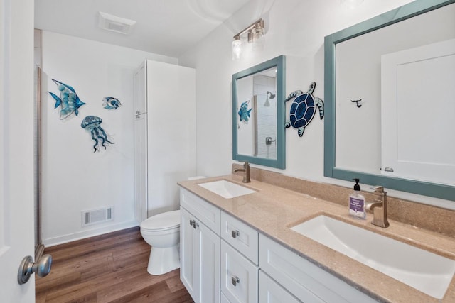1451 Whalen Dr, Oconomowoc, WI 53066 - bathroom featuring a stall shower, double vanity, and wood finished floors