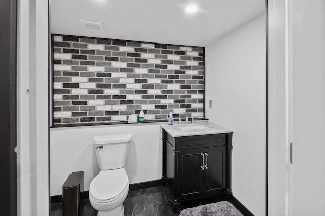 1451 Whalen Dr, Oconomowoc, WI 53066 - bathroom featuring decorative backsplash, vanity, marble finish floors, and recessed lighting