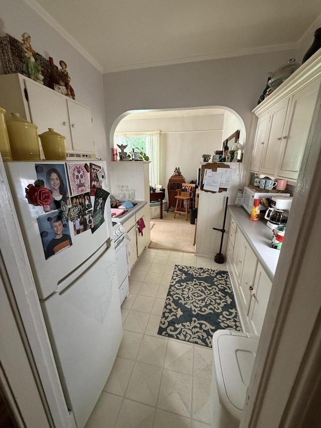 525 Dunbar Ave, Waukesha, WI 53186 - kitchen with arched walkways, freestanding refrigerator, ornamental molding, and light countertops