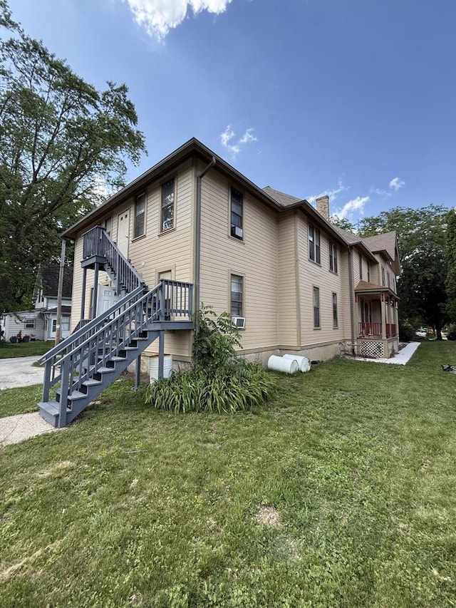 525 Dunbar Ave, Waukesha, WI 53186 - view of home's exterior with a yard, a chimney, and stairway