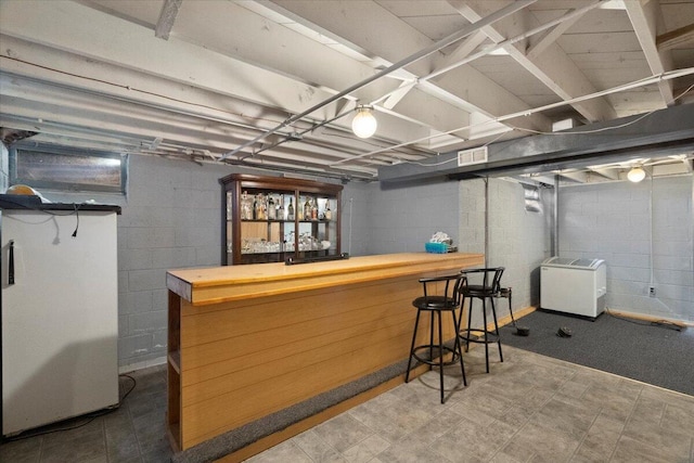 3021 Dwight St, Racine, WI 53403 - indoor dry bar with washer / dryer, tile patterned floors, and concrete block wall