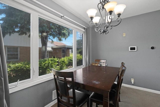3021 Dwight St, Racine, WI 53403 - carpeted dining area featuring a chandelier and baseboards