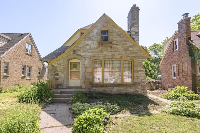 3940 N 64th St, Milwaukee, WI 53216 - tudor-style house with stone siding and a chimney