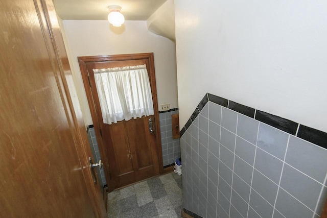 3940 N 64th St, Milwaukee, WI 53216 - doorway to outside featuring tile walls and wainscoting