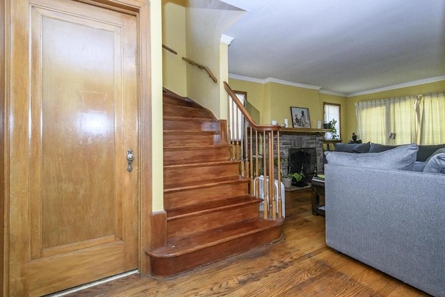 3940 N 64th St, Milwaukee, WI 53216 - living area with wood finished floors, stairs, crown molding, and a stone fireplace