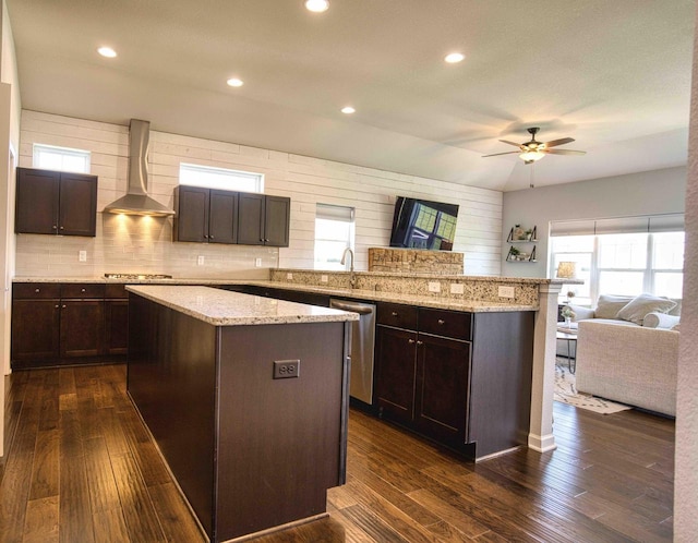 W195N5814 Deer Park Ct, Menomonee Falls, WI 53051 - kitchen with wall chimney range hood, appliances with stainless steel finishes, open floor plan, a kitchen island, and a ceiling fan