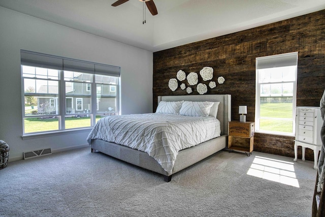 W195N5814 Deer Park Ct, Menomonee Falls, WI 53051 - carpeted bedroom with multiple windows, a ceiling fan, and wooden walls