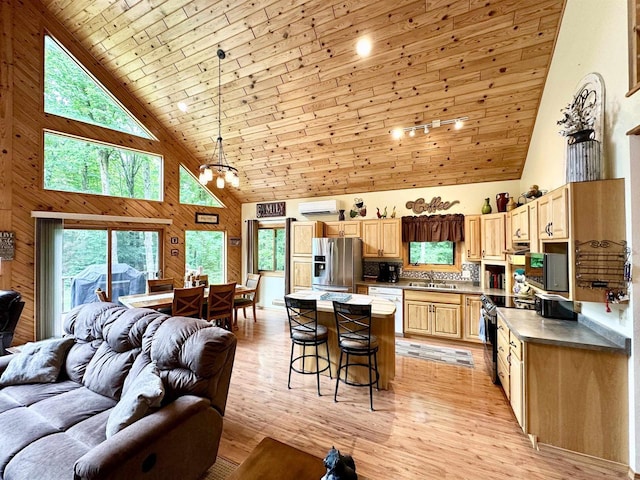 N6448 Neva Lake Rd, Deerbrook, WI 54424 - kitchen featuring high vaulted ceiling, open floor plan, electric range oven, white dishwasher, and a breakfast bar area