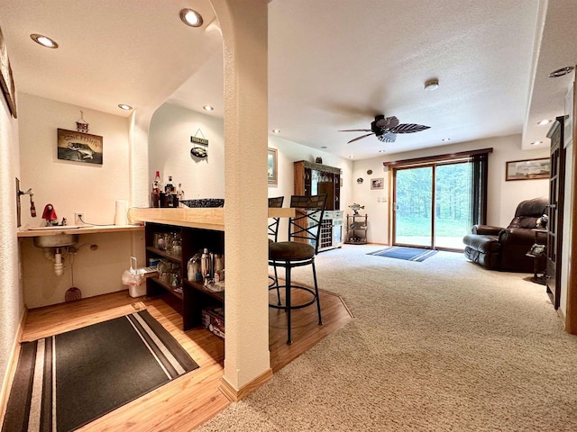 N6448 Neva Lake Rd, Deerbrook, WI 54424 - bar with ceiling fan, recessed lighting, carpet floors, arched walkways, and wood finished floors