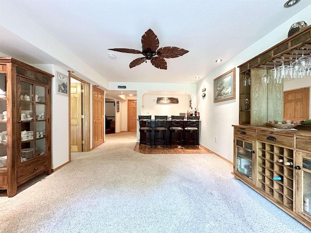 N6448 Neva Lake Rd, Deerbrook, WI 54424 - carpeted living room featuring arched walkways, ceiling fan, and bar