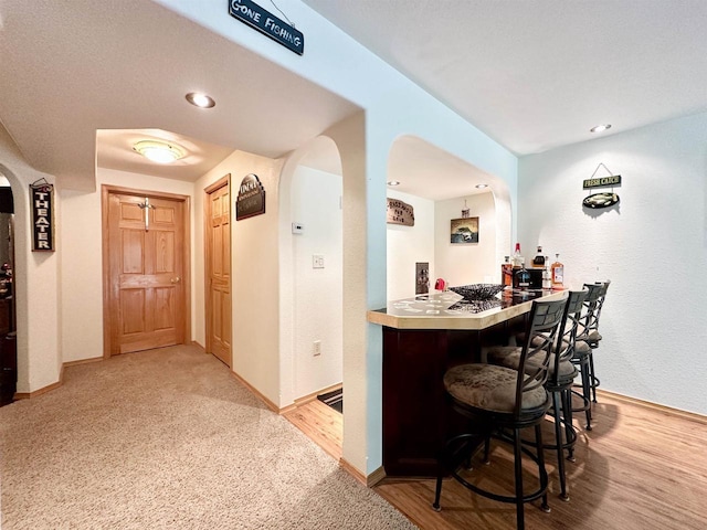 N6448 Neva Lake Rd, Deerbrook, WI 54424 - indoor dry bar with arched walkways and light wood-type flooring