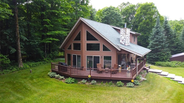 N6448 Neva Lake Rd, Deerbrook, WI 54424 - rear view of property featuring a wooden deck, a lawn, a chimney, and a forest view