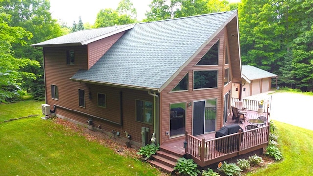 N6448 Neva Lake Rd, Deerbrook, WI 54424 - rear view of house with a yard, a wooden deck, a shingled roof, and a garage