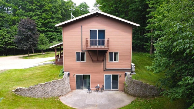 N6448 Neva Lake Rd, Deerbrook, WI 54424 - back of house featuring a balcony, a lawn, and a patio