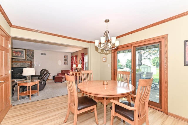 2191 W Hope Ln, Oak Creek, WI 53154 - dining room with a chandelier, light wood-style floors, a fireplace, and ornamental molding