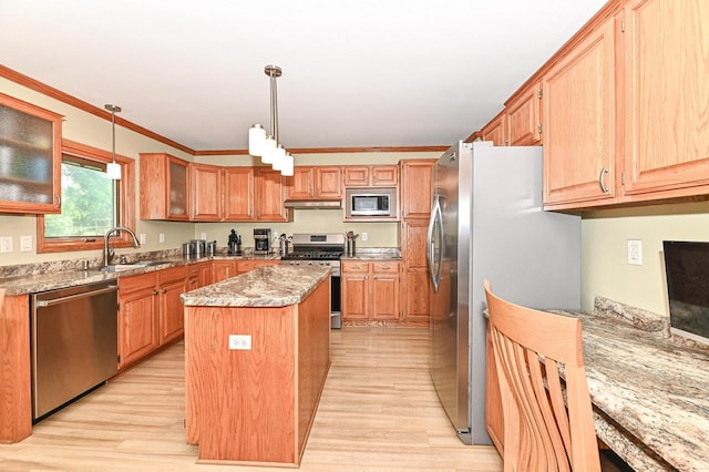 2191 W Hope Ln, Oak Creek, WI 53154 - kitchen featuring stainless steel appliances, light wood finished floors, a center island, under cabinet range hood, and light stone counters