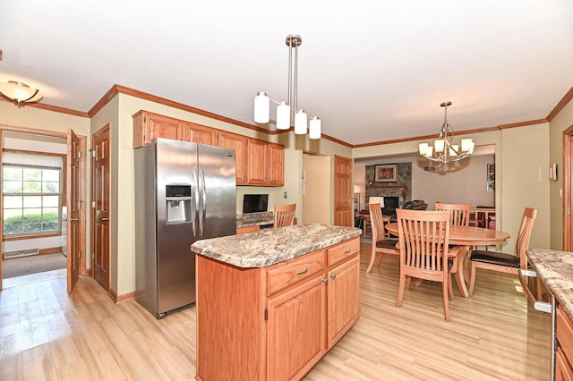 2191 W Hope Ln, Oak Creek, WI 53154 - kitchen featuring stainless steel fridge with ice dispenser, light wood-type flooring, a center island, ornamental molding, and hanging light fixtures