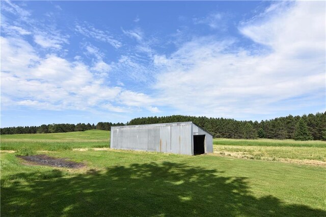 15754 County Highway M, New Auburn, WI 54757 - view of grassy yard featuring a pole building, a view of trees, an outdoor structure, and a view of rural / pastoral area