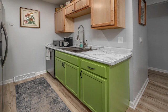 1363 Josephine St Unit E, Waukesha, WI 53186 - kitchen featuring stainless steel dishwasher, light countertops, and light wood-style flooring