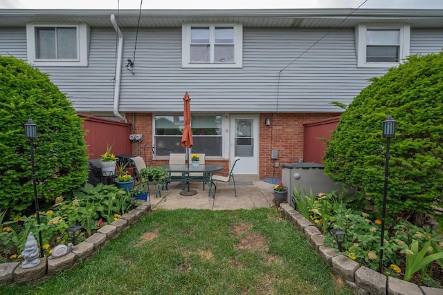 1363 Josephine St Unit E, Waukesha, WI 53186 - rear view of house with a patio and brick siding