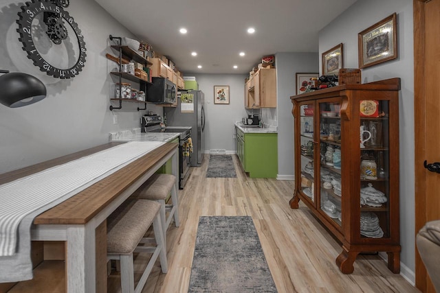 1363 Josephine St Unit E, Waukesha, WI 53186 - kitchen featuring appliances with stainless steel finishes, light countertops, light wood-type flooring, recessed lighting, and open shelves