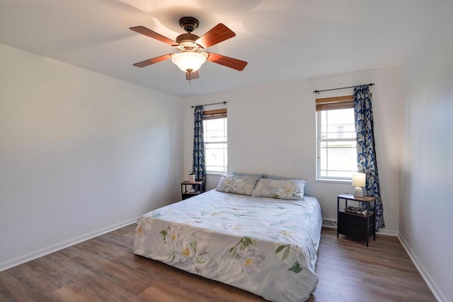 408 Juniper St, Brooklyn, WI 53521 - bedroom with multiple windows, wood finished floors, and a ceiling fan