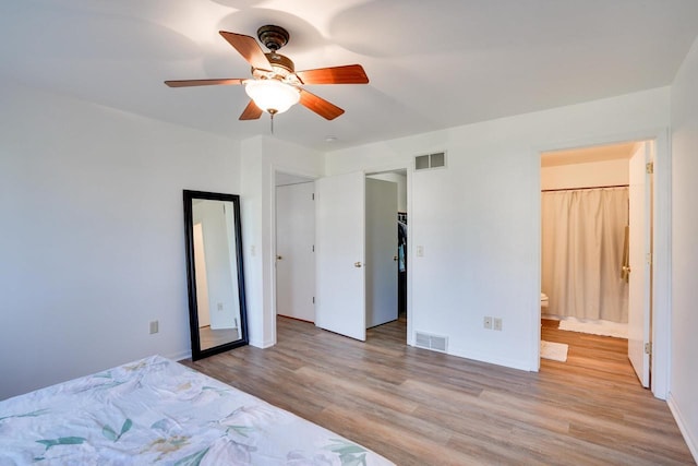 408 Juniper St, Brooklyn, WI 53521 - bedroom featuring wood finished floors, ensuite bathroom, and a ceiling fan