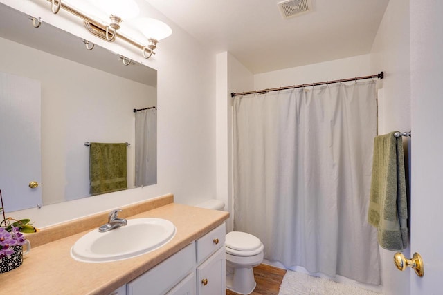 408 Juniper St, Brooklyn, WI 53521 - full bathroom featuring vanity, a shower with shower curtain, and wood finished floors