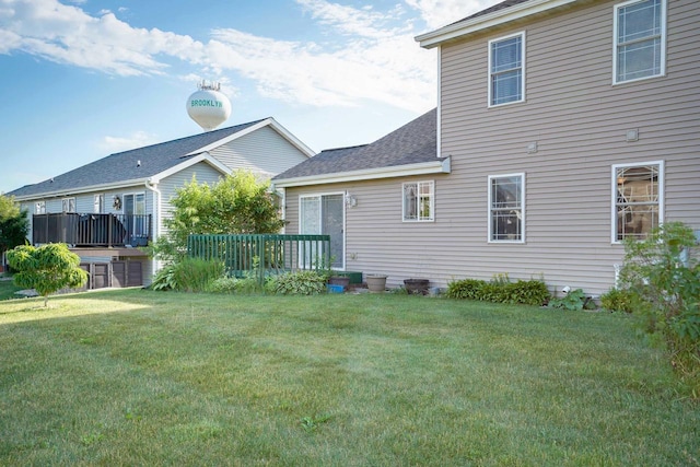 408 Juniper St, Brooklyn, WI 53521 - back of house featuring a lawn, roof with shingles, and a wooden deck
