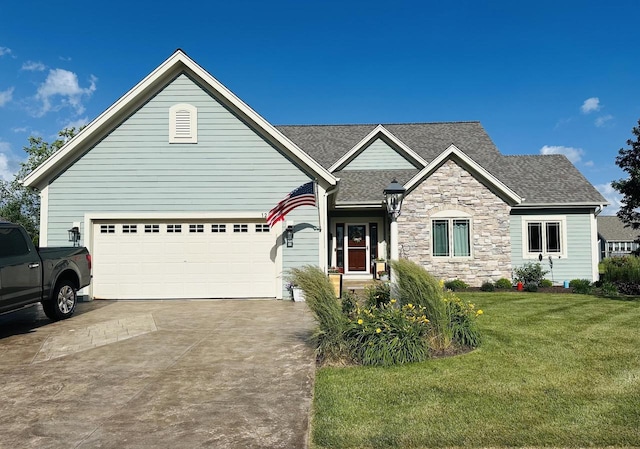 1255 Winterberry Rd, Oconomowoc, WI 53066 - view of front of property featuring concrete driveway, a front lawn, an attached garage, stone siding, and roof with shingles