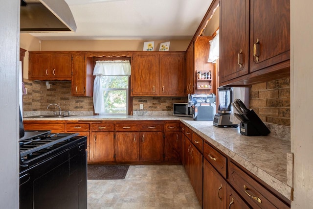 3011 16th St, Racine, WI 53405 - kitchen featuring black range with gas cooktop, light countertops, backsplash, and brown cabinets