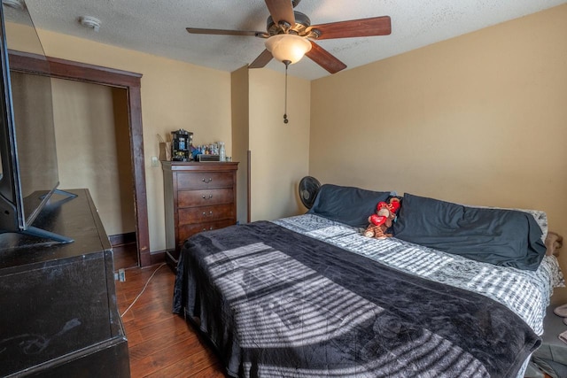 3011 16th St, Racine, WI 53405 - bedroom with dark wood-style flooring, ceiling fan, and a textured ceiling