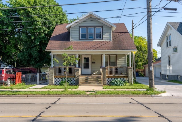 3011 16th St, Racine, WI 53405 - bungalow featuring a porch, a garage, and roof with shingles
