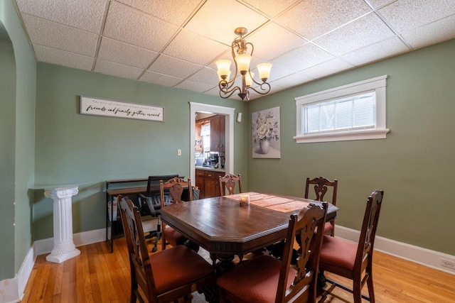 3011 16th St, Racine, WI 53405 - dining space featuring a drop ceiling, light wood-type flooring, a chandelier, and arched walkways