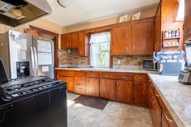 3011 16th St, Racine, WI 53405 - kitchen featuring appliances with stainless steel finishes, exhaust hood, light countertops, and brown cabinets