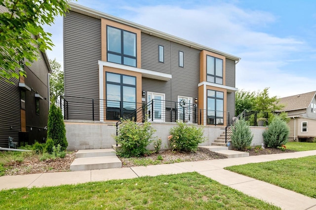 217 N Van Buren St, Green Bay, WI 54301 - contemporary home featuring a front yard and stairs