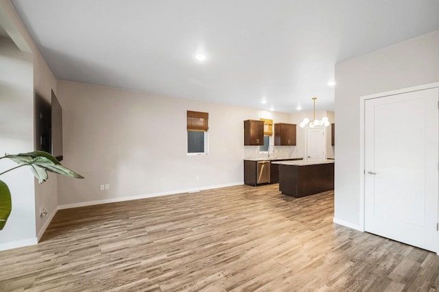 217 N Van Buren St, Green Bay, WI 54301 - unfurnished living room featuring a chandelier, light wood-style floors, and recessed lighting